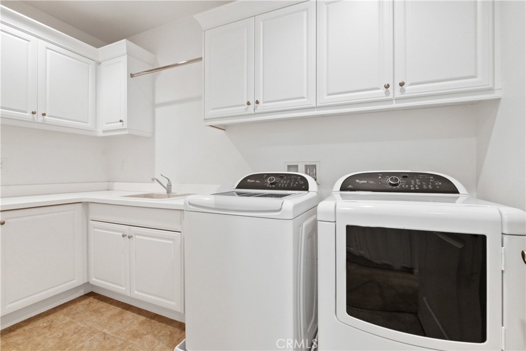 64 Hazelton Irvine, CA 92620 - Photo 20 of 23 a utility room with sink dryer and washer