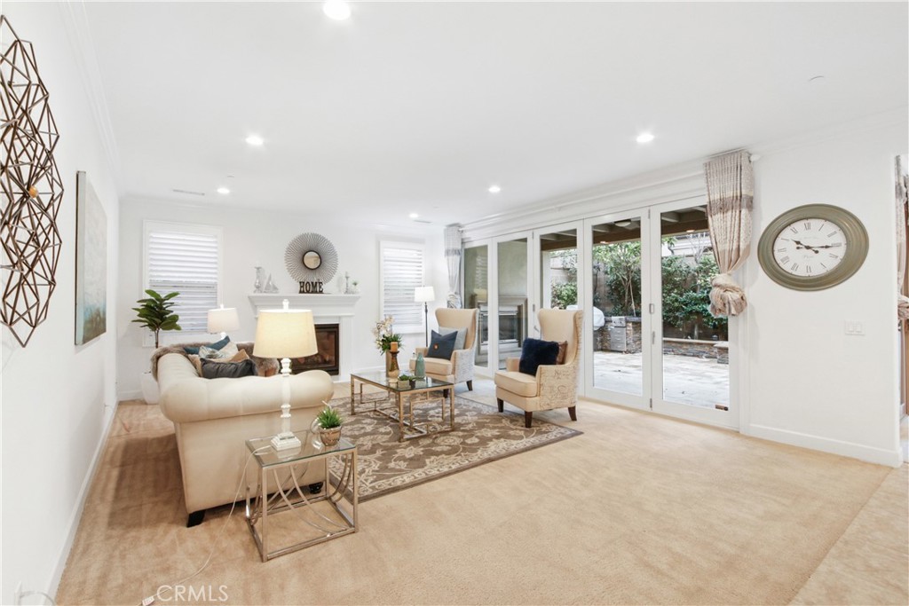 64 Hazelton Irvine, CA 92620 - Photo 3 of 23 a living room with furniture a clock and a large window