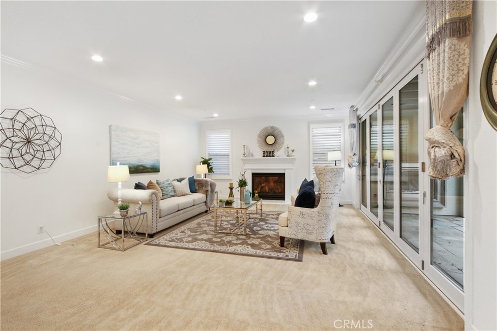 64 Hazelton Irvine, CA 92620 - Photo 4 of 23 a living room with furniture a fireplace and a table