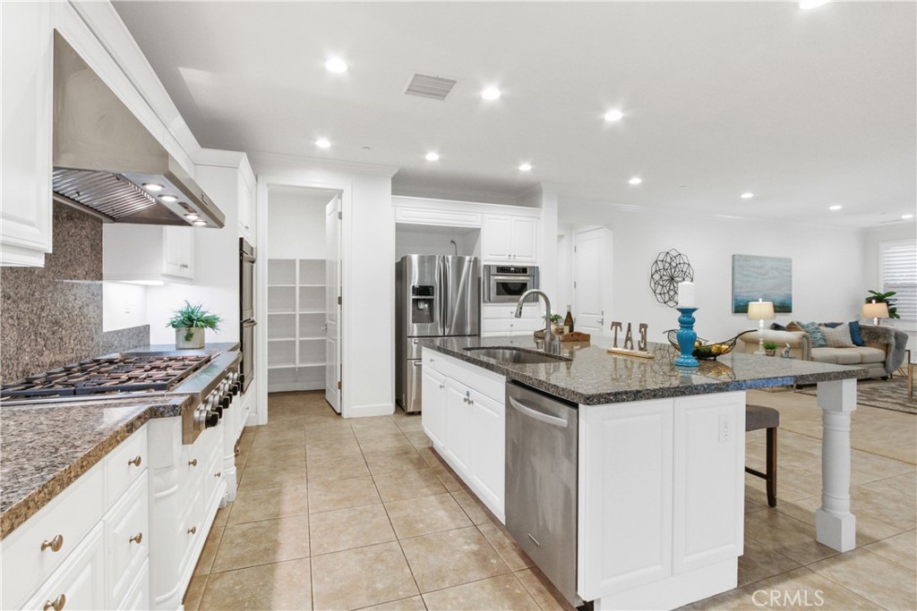 64 Hazelton Irvine, CA 92620 - Photo 7 of 23 a kitchen with stainless steel appliances granite countertop a stove and cabinets