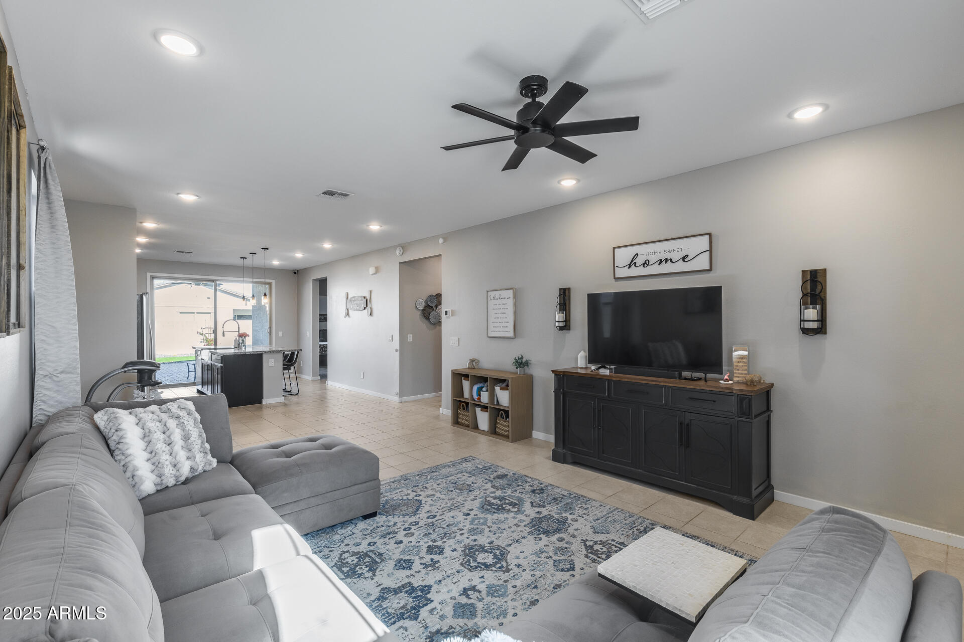 19920 West Rancho Drive Litchfield Park, AZ 85340 - Photo 11 of 49 a living room with furniture and a flat screen tv