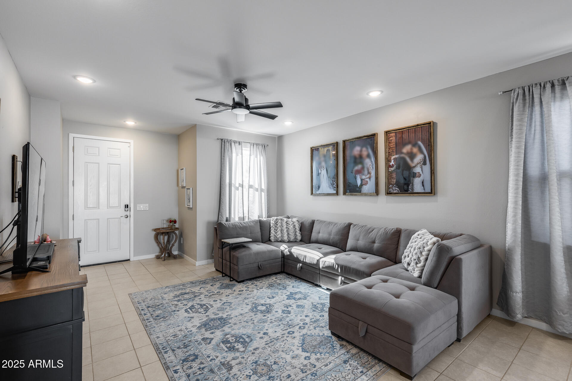 19920 West Rancho Drive Litchfield Park, AZ 85340 - Photo 12 of 49 a living room with furniture and a flat screen tv