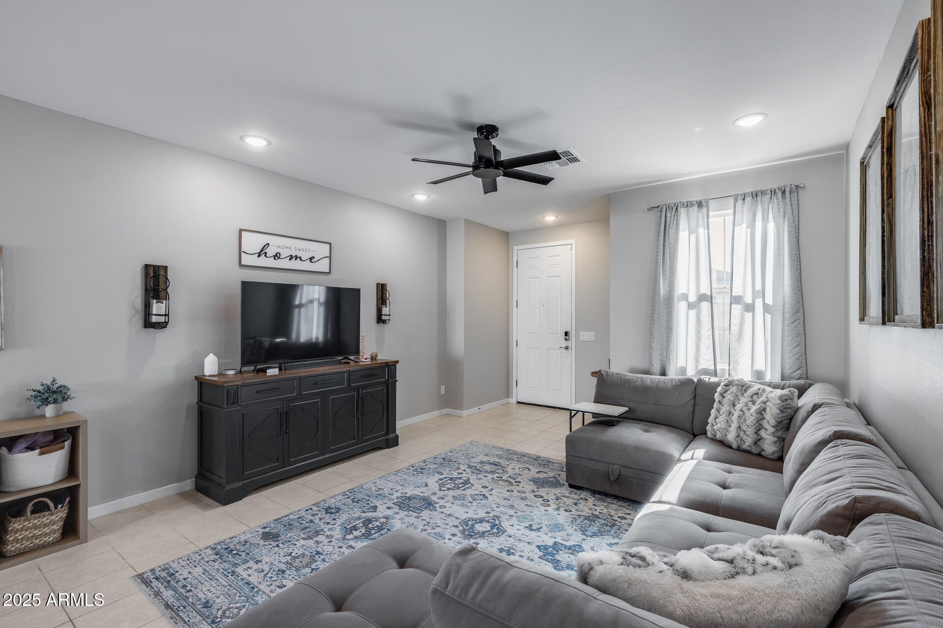 19920 West Rancho Drive Litchfield Park, AZ 85340 - Photo 13 of 49 a living room with furniture and a flat screen tv