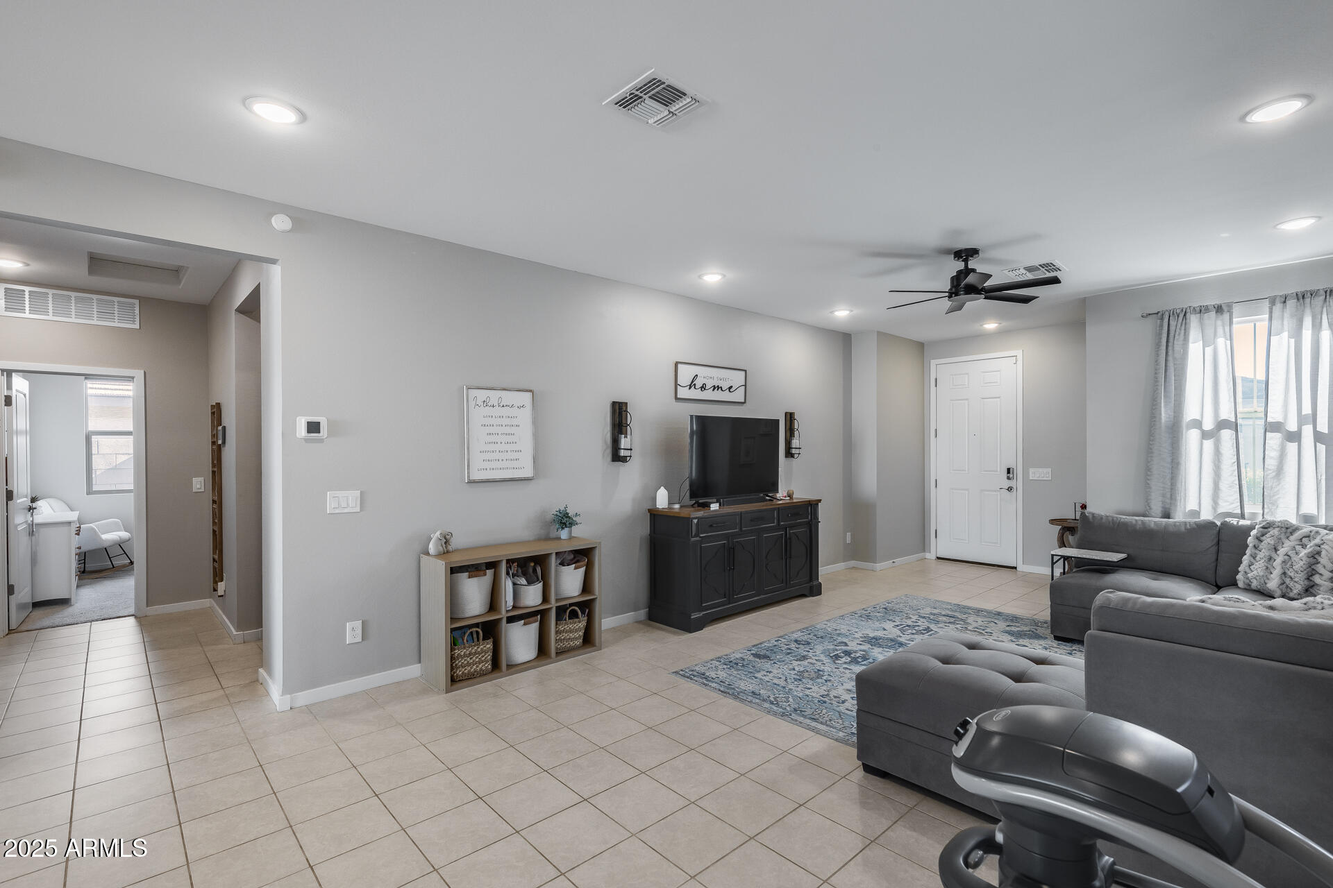 19920 West Rancho Drive Litchfield Park, AZ 85340 - Photo 15 of 49 a living room with furniture and a flat screen tv