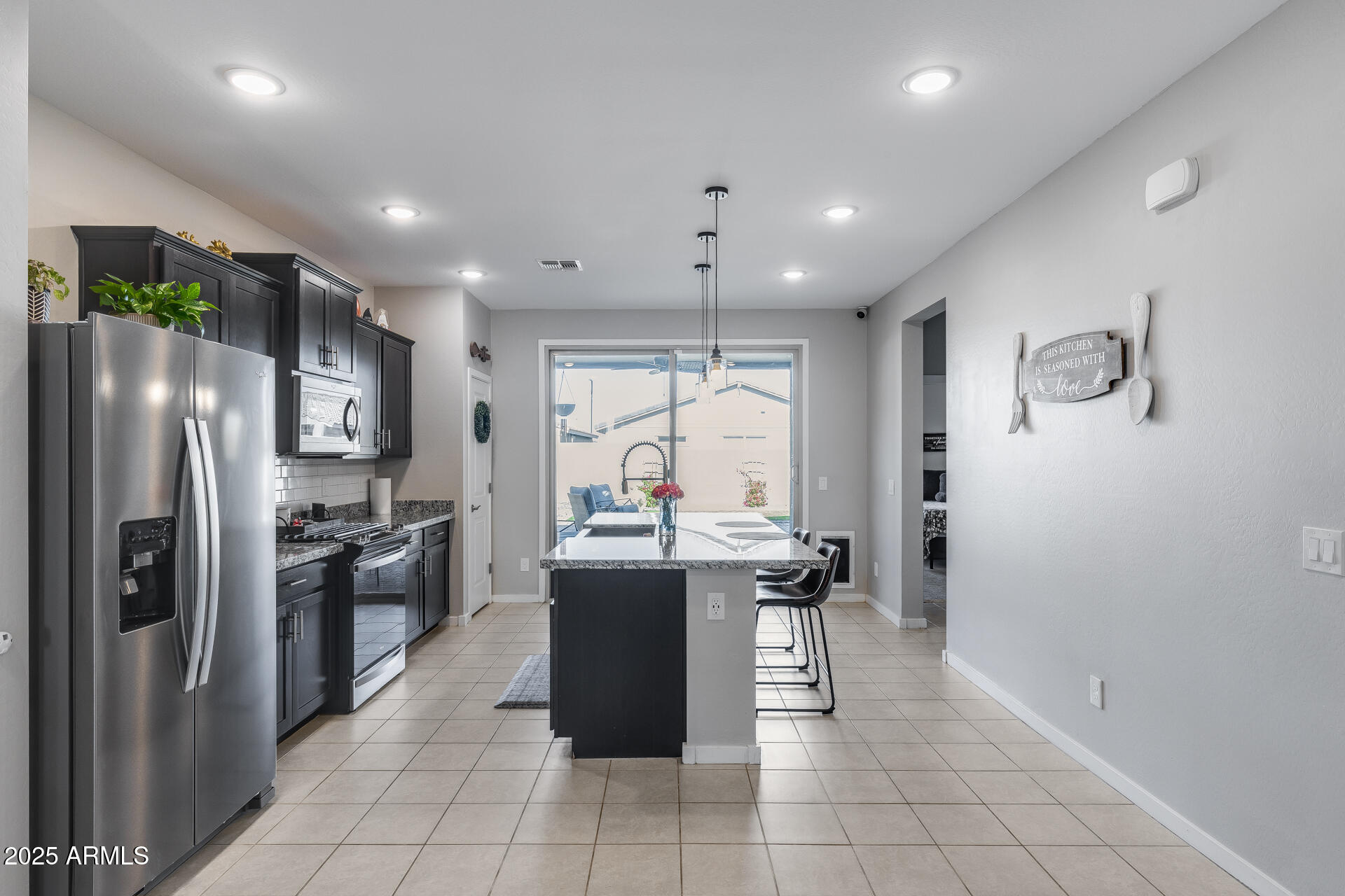 19920 West Rancho Drive Litchfield Park, AZ 85340 - Photo 16 of 49 a kitchen with stainless steel appliances granite countertop a refrigerator and a stove