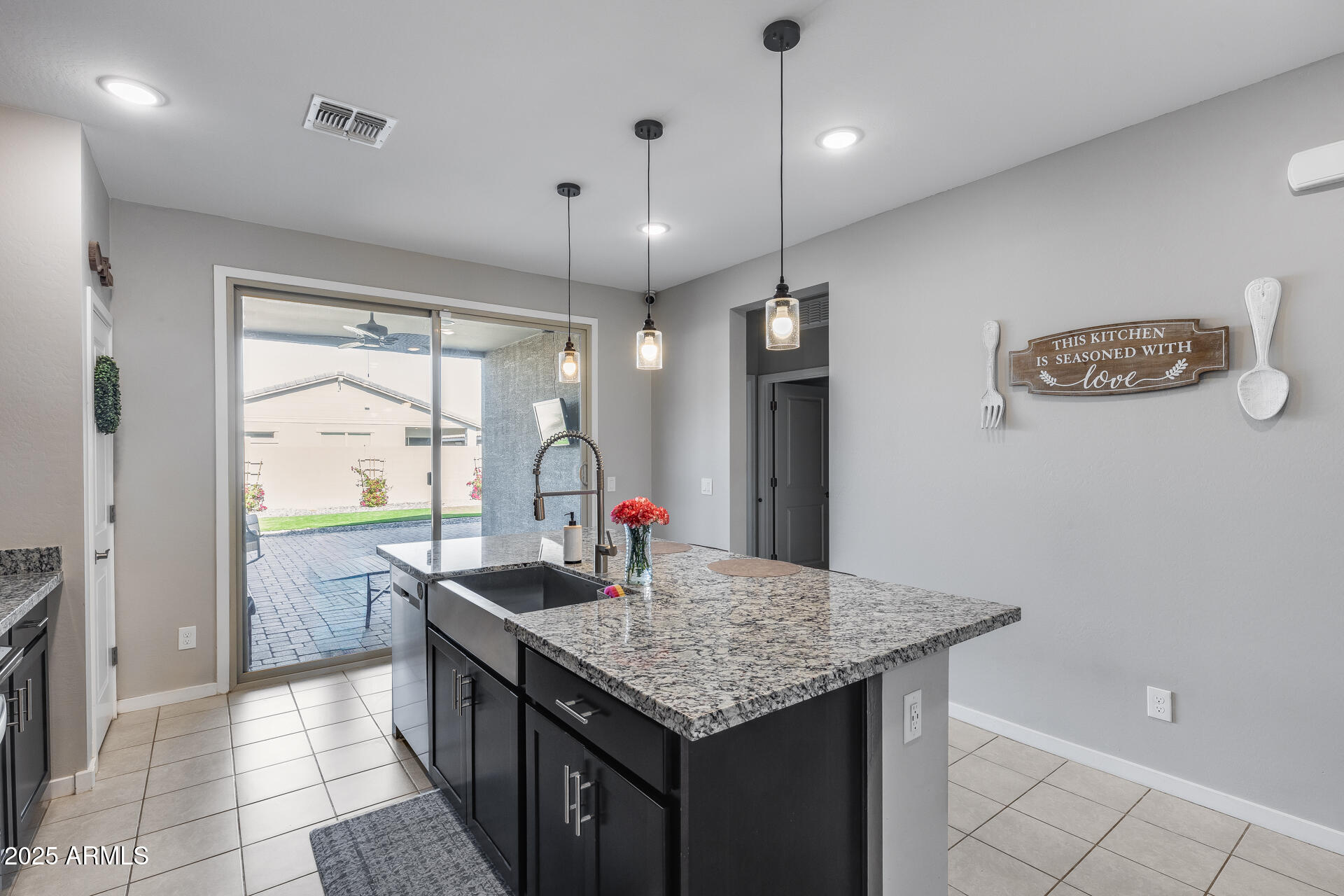 19920 West Rancho Drive Litchfield Park, AZ 85340 - Photo 19 of 49 a kitchen with granite countertop a sink a counter top space and stainless steel appliances