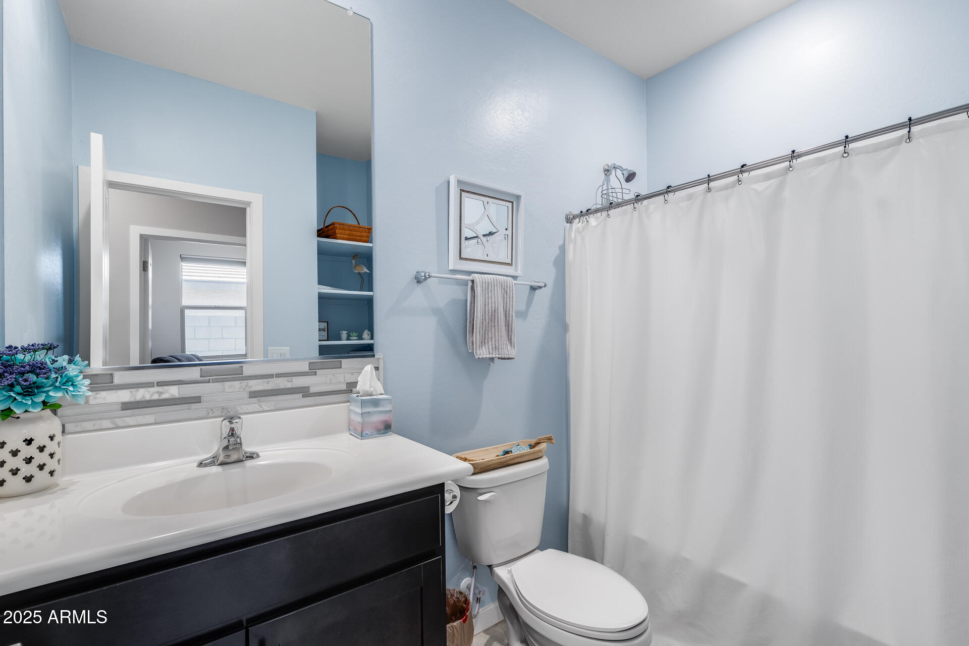 19920 West Rancho Drive Litchfield Park, AZ 85340 - Photo 28 of 49 a bathroom with a sink vanity mirror and toilet