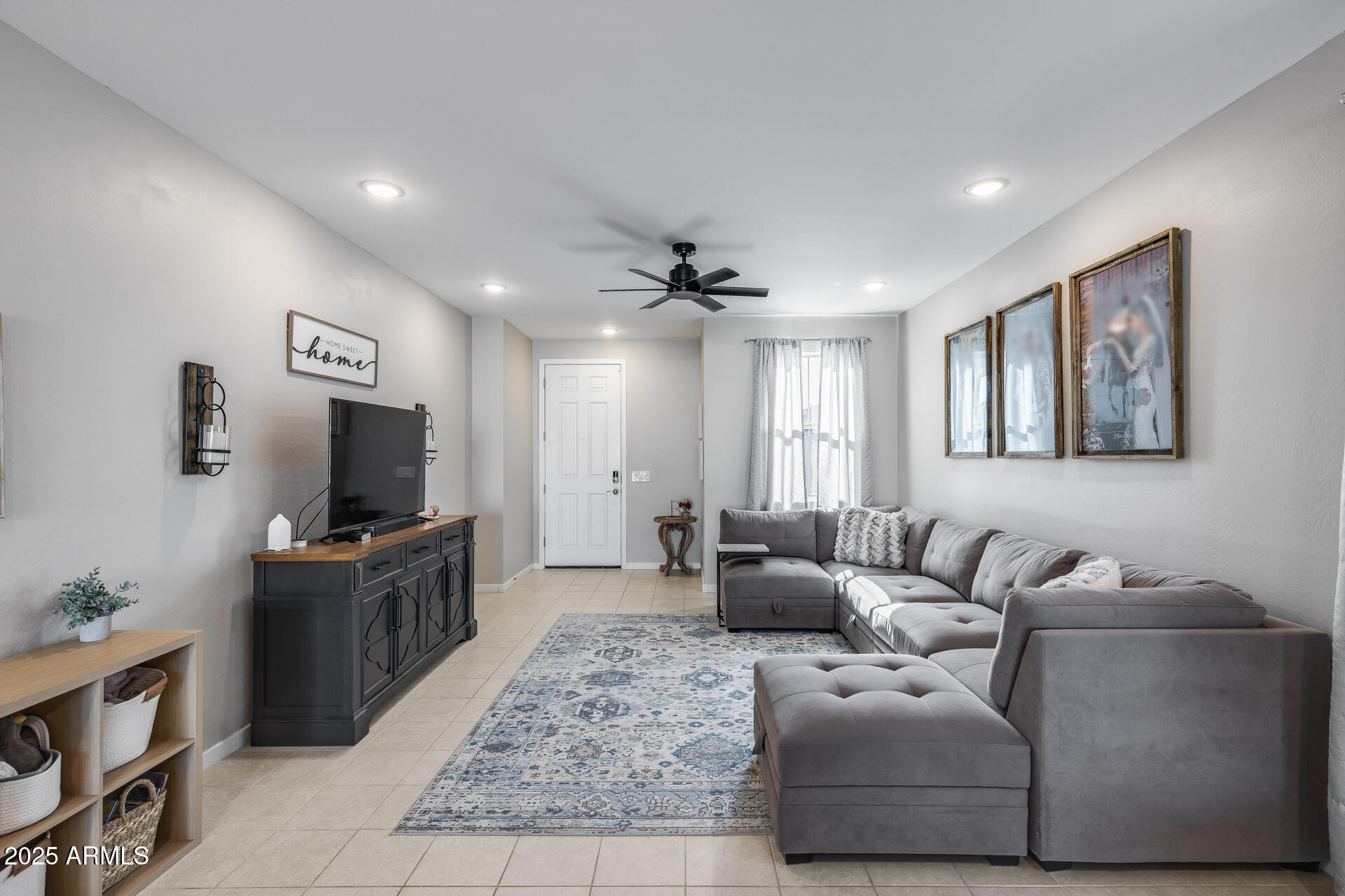 19920 West Rancho Drive Litchfield Park, AZ 85340 - Photo 2 of 49 a living room with furniture and a flat screen tv