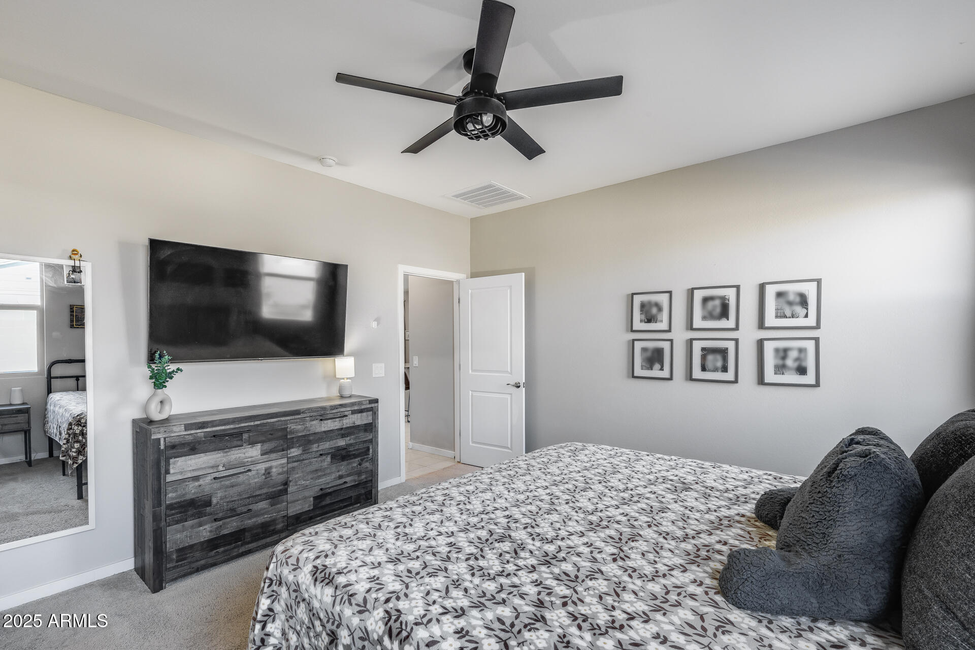 19920 West Rancho Drive Litchfield Park, AZ 85340 - Photo 32 of 49 a bedroom with a bed and a flat screen tv