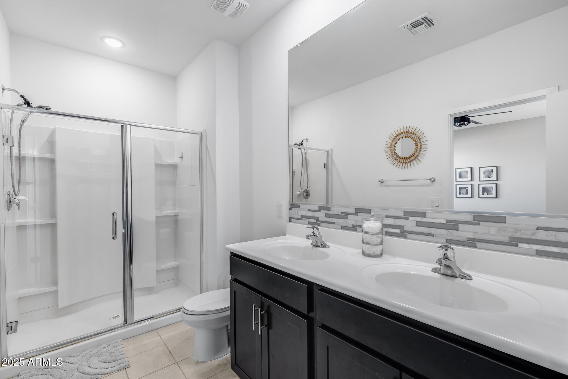 19920 West Rancho Drive Litchfield Park, AZ 85340 - Photo 34 of 49 a bathroom with a double vanity sink mirror and toilet