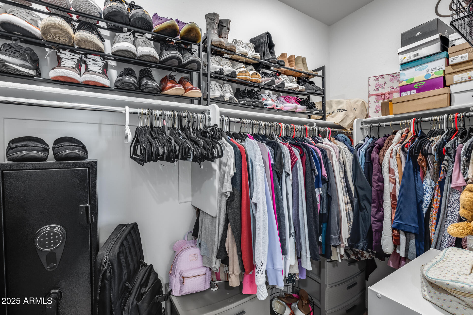 19920 West Rancho Drive Litchfield Park, AZ 85340 - Photo 35 of 49 a view of walk in closet with clothes and shoes