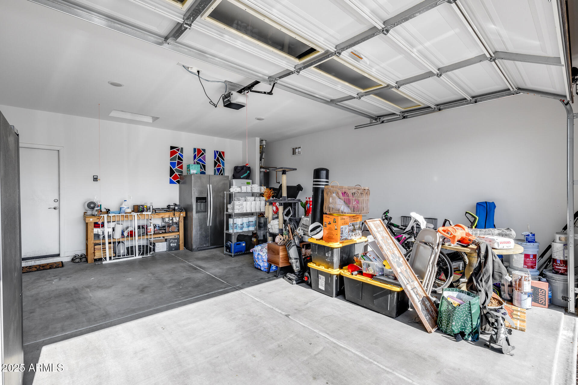 19920 West Rancho Drive Litchfield Park, AZ 85340 - Photo 36 of 49 a view of a garage with a bike and car