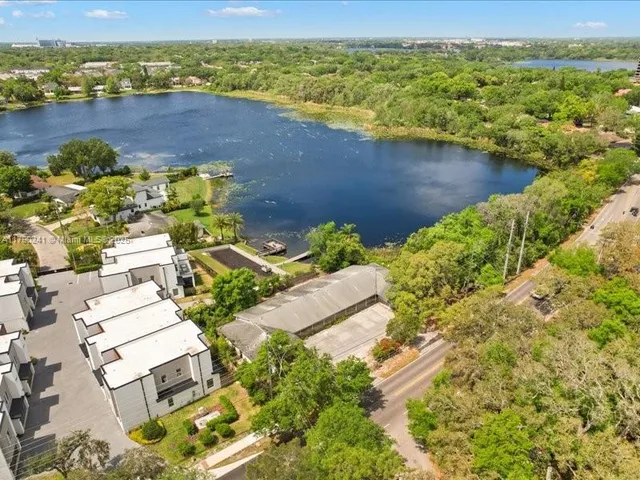 an aerial view of a house with a lake view