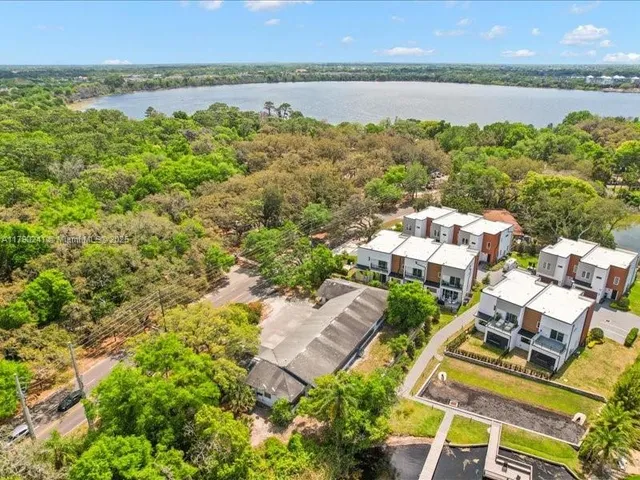 an aerial view of residential building with outdoor space and lake view