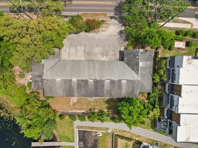 an aerial view of a house with a yard