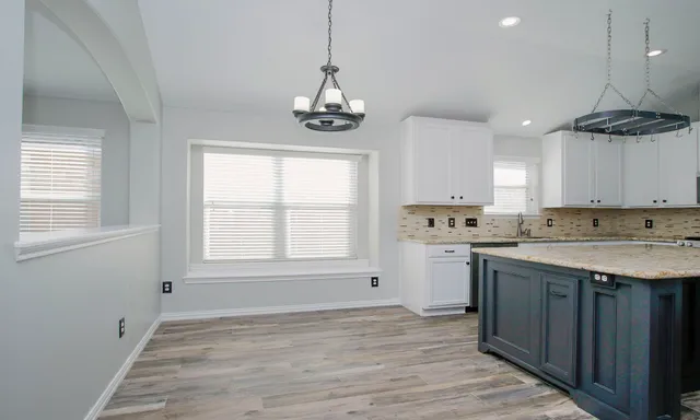 a kitchen with stainless steel appliances granite countertop a sink a stove a refrigerator and window