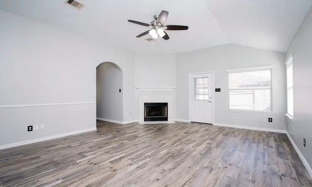 wooden floor in an empty room with a fireplace