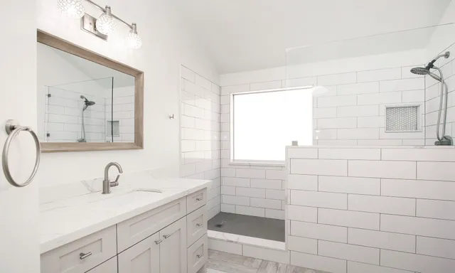 a bathroom with a sink a toilet and mirror