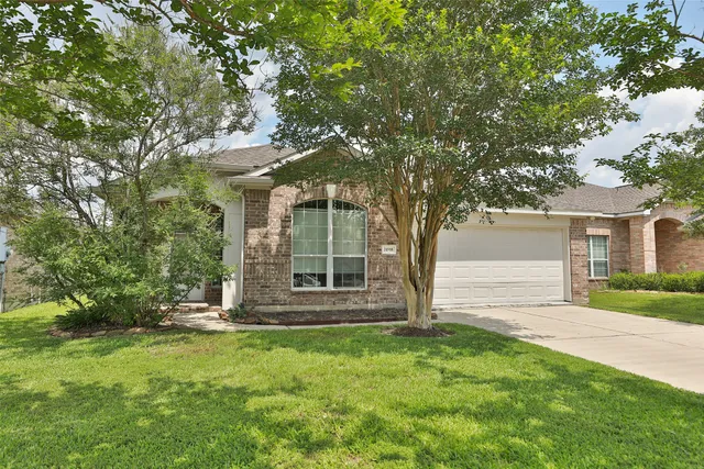 front view of a house with a tree