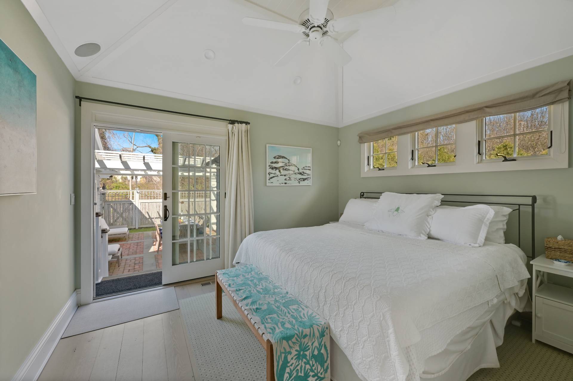 5 Ridge Drive Sag Harbor, NY 11963 - Photo 9 of 27 a bedroom with a large bed and a chandelier