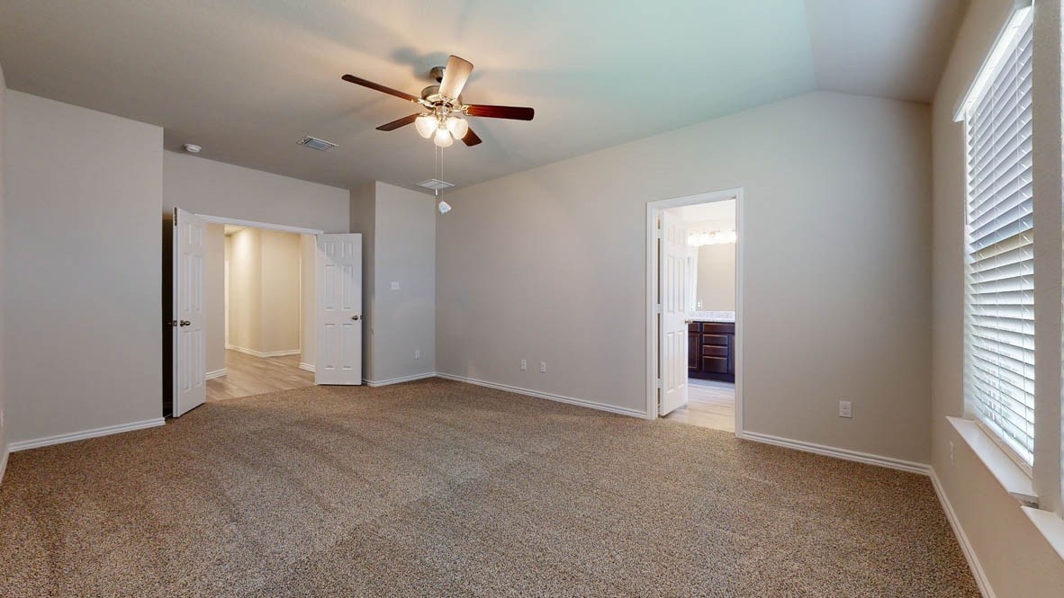 104 Kenzie Street Thorndale, TX 76577 - Photo 12 of 28 an empty room with windows and fan