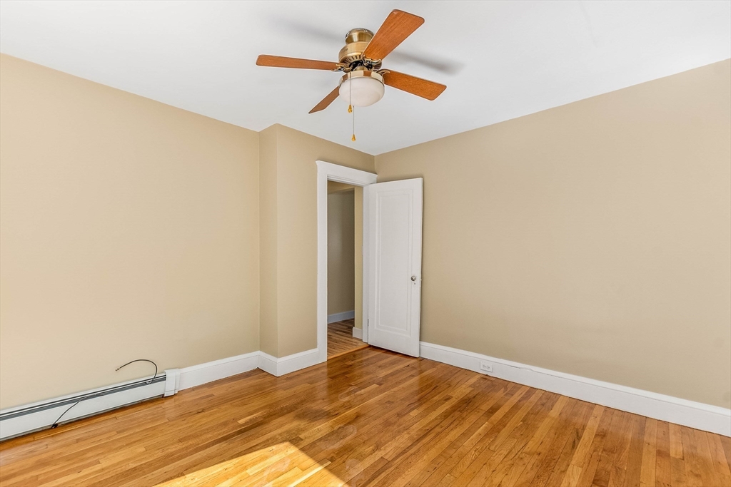 1 Columbia Terrace Dedham, MA 02026 - Photo 11 of 24 a view of empty room with wooden floor and fan