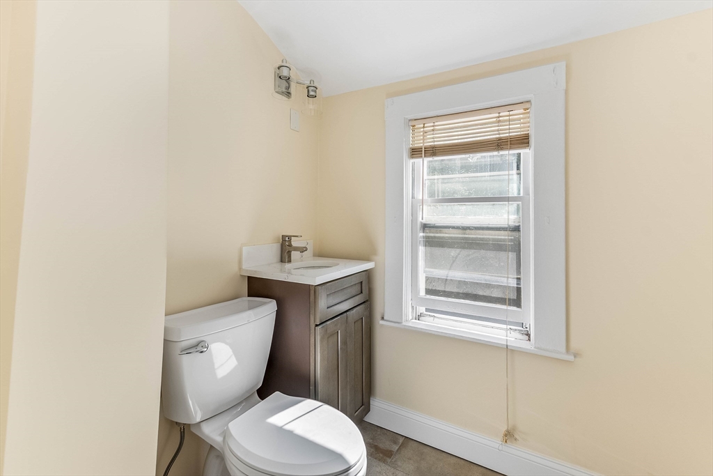 1 Columbia Terrace Dedham, MA 02026 - Photo 14 of 24 a white toilet sitting next to a bathroom sink
