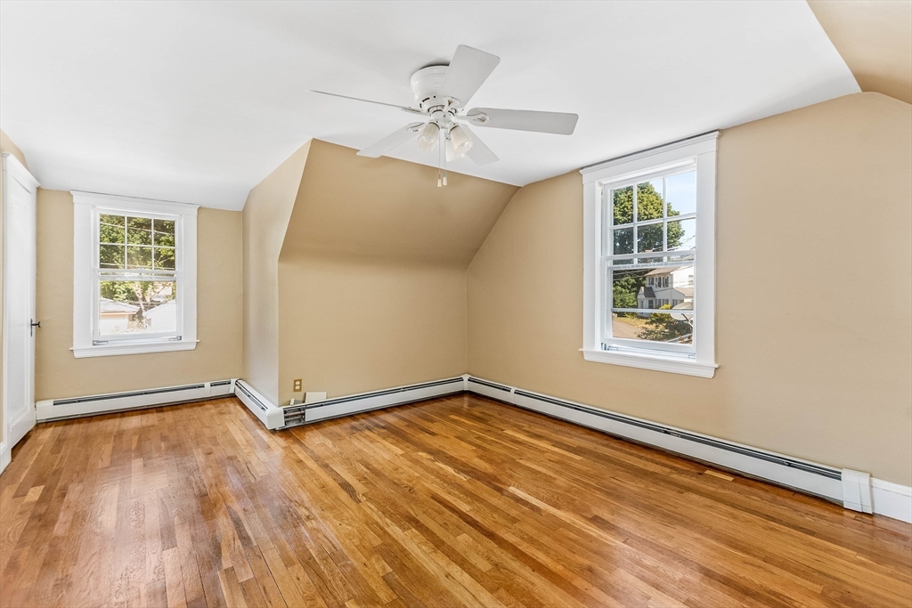 1 Columbia Terrace Dedham, MA 02026 - Photo 15 of 24 a view of an empty room with a window and wooden floor