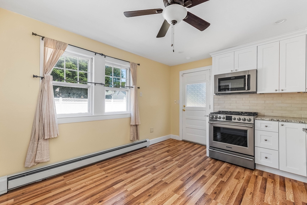 1 Columbia Terrace Dedham, MA 02026 - Photo 6 of 24 a kitchen with stainless steel appliances a stove top oven a sink and a chandelier