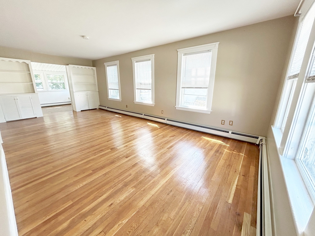1 Columbia Terrace Dedham, MA 02026 - Photo 7 of 24 a view of an empty room with wooden floor and a window