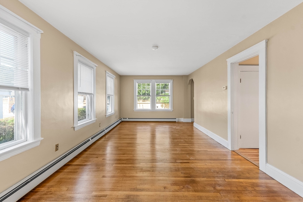 1 Columbia Terrace Dedham, MA 02026 - Photo 8 of 24 a view of an empty room with wooden floor and a window