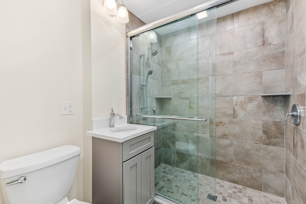 1 Columbia Terrace Dedham, MA 02026 - Photo 9 of 24 a bathroom with a sink toilet and shower