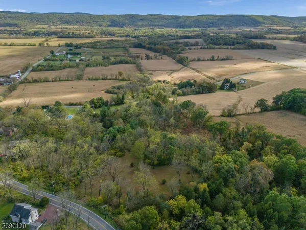 an aerial view of residential houses with outdoor space and river