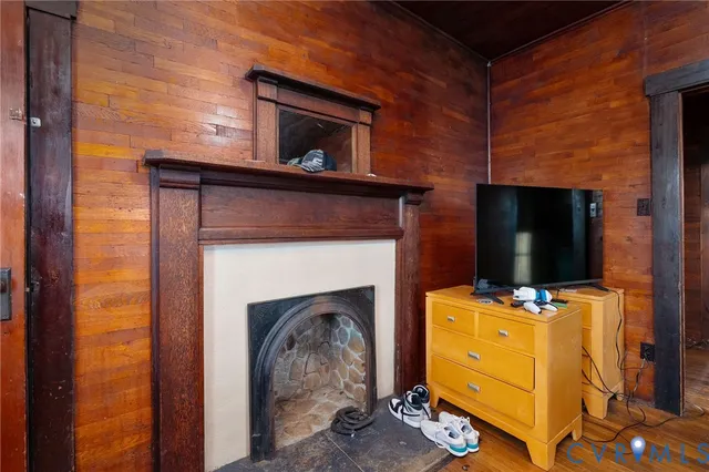 a living room with a fireplace and a flat screen tv