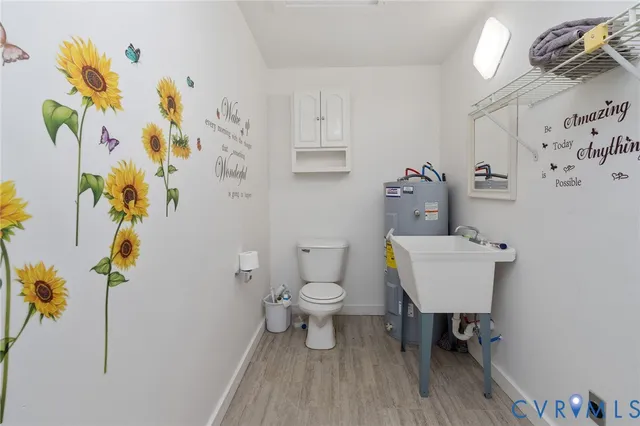 a white toilet sitting next to a bathroom sink