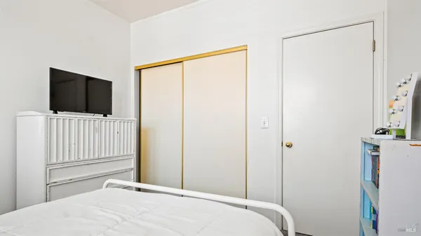 a bedroom with a bed and a flat screen tv