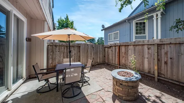 a view of a patio with table and chairs potted plants