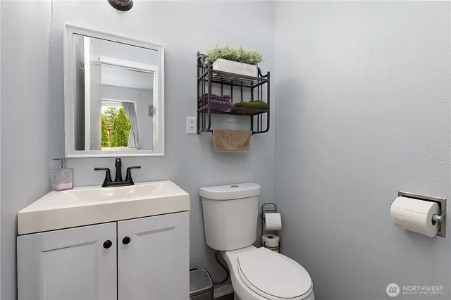 a bathroom with a toilet sink and mirror