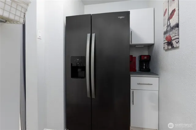 a kitchen with a refrigerator and cabinets