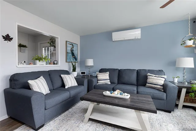 a living room with furniture and a lamp