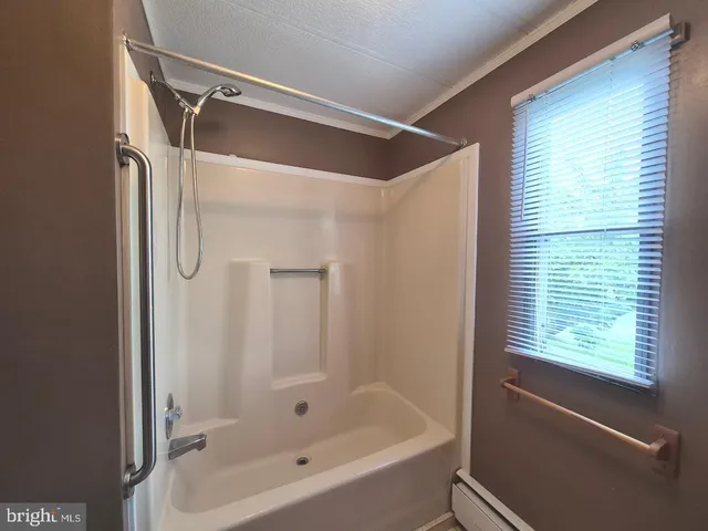 a bathroom with a bathtub and a shower