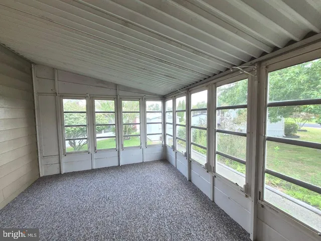 a view of an empty room with large windows