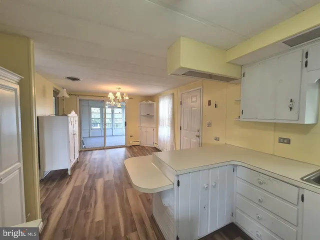 a view of a kitchen cabinets a sink and wooden floor