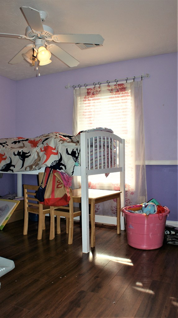 398 Owens Road Fort Mitchell, AL 36856 - Photo 13 of 17 a bedroom with furniture window and wooden floor