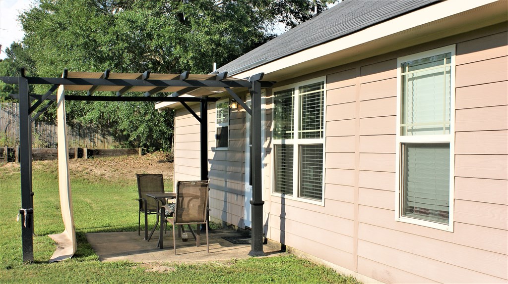 398 Owens Road Fort Mitchell, AL 36856 - Photo 16 of 17 a view of a chair and table in backyard of the house