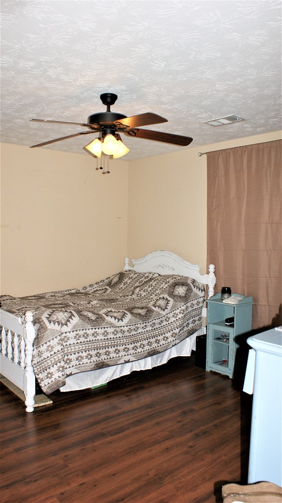 398 Owens Road Fort Mitchell, AL 36856 - Photo 6 of 17 a bedroom with a bed and wooden floor