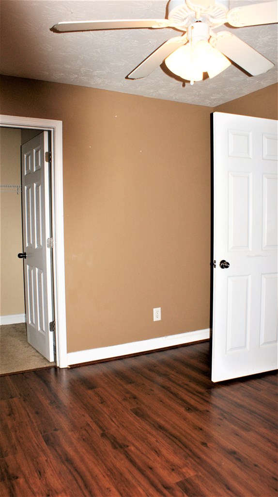 398 Owens Road Fort Mitchell, AL 36856 - Photo 9 of 17 an empty room with wooden floor and windows