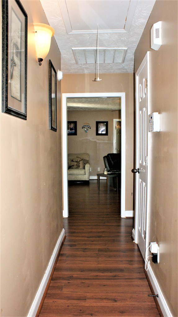 398 Owens Road Fort Mitchell, AL 36856 - Photo 10 of 17 a view of a hallway with wooden floor and chandelier