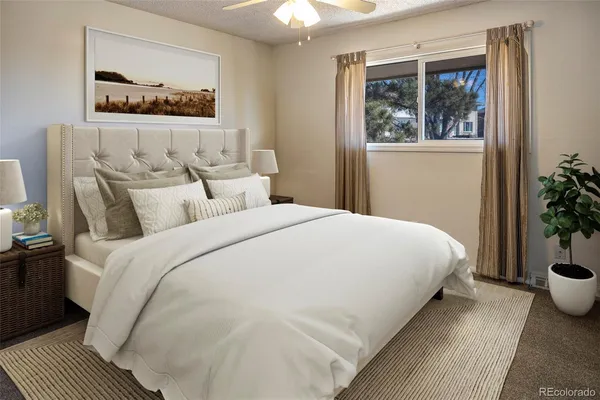 a bed room with furniture and a potted plant