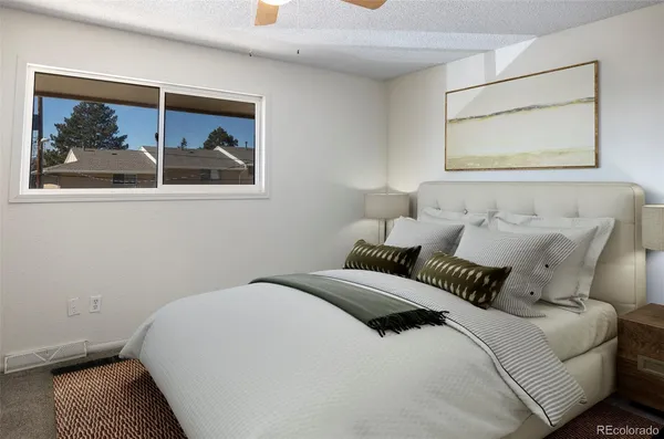 a bedroom with a bed and a painting on the wall